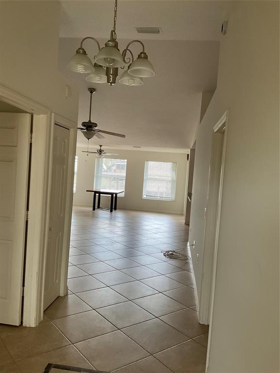 2422 Southeast 33rd Street Okeechobee, FL 34974 - Photo 31 of 32 a view of a hallway with a chandelier