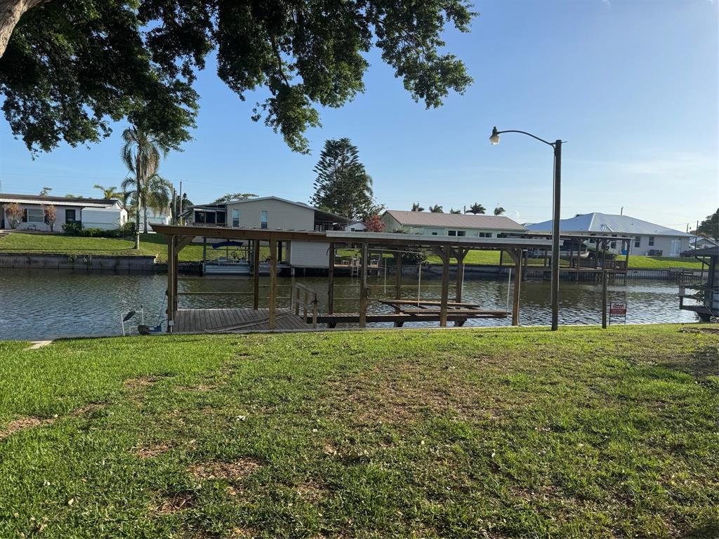 2422 Southeast 33rd Street Okeechobee, FL 34974 - Photo 9 of 32 a view of a garden with a bench under an umbrella