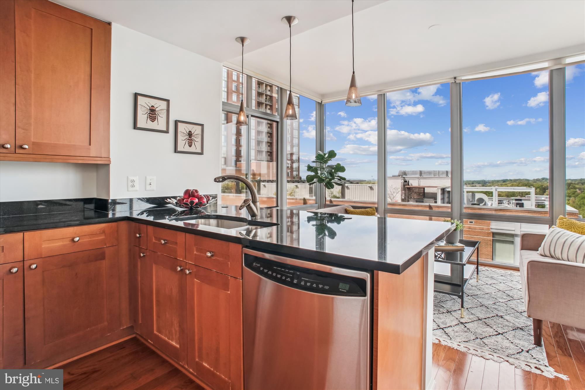 11990 Market Street, Unit 805 Reston, VA 20190 - Photo 11 of 53 a kitchen with stainless steel appliances granite countertop a sink a counter top space and living room view