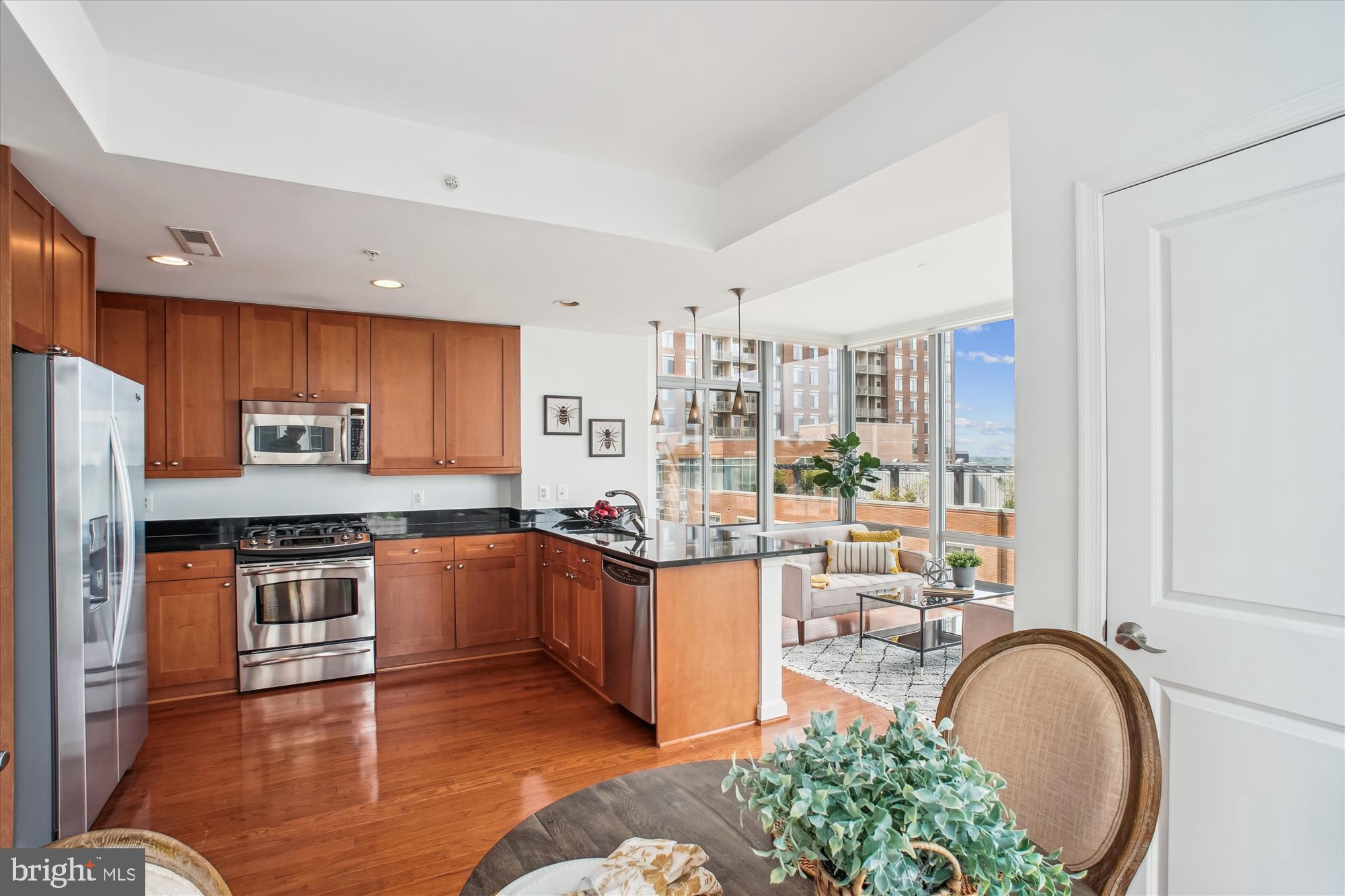 11990 Market Street, Unit 805 Reston, VA 20190 - Photo 16 of 53 a kitchen with stainless steel appliances granite countertop a stove and a refrigerator