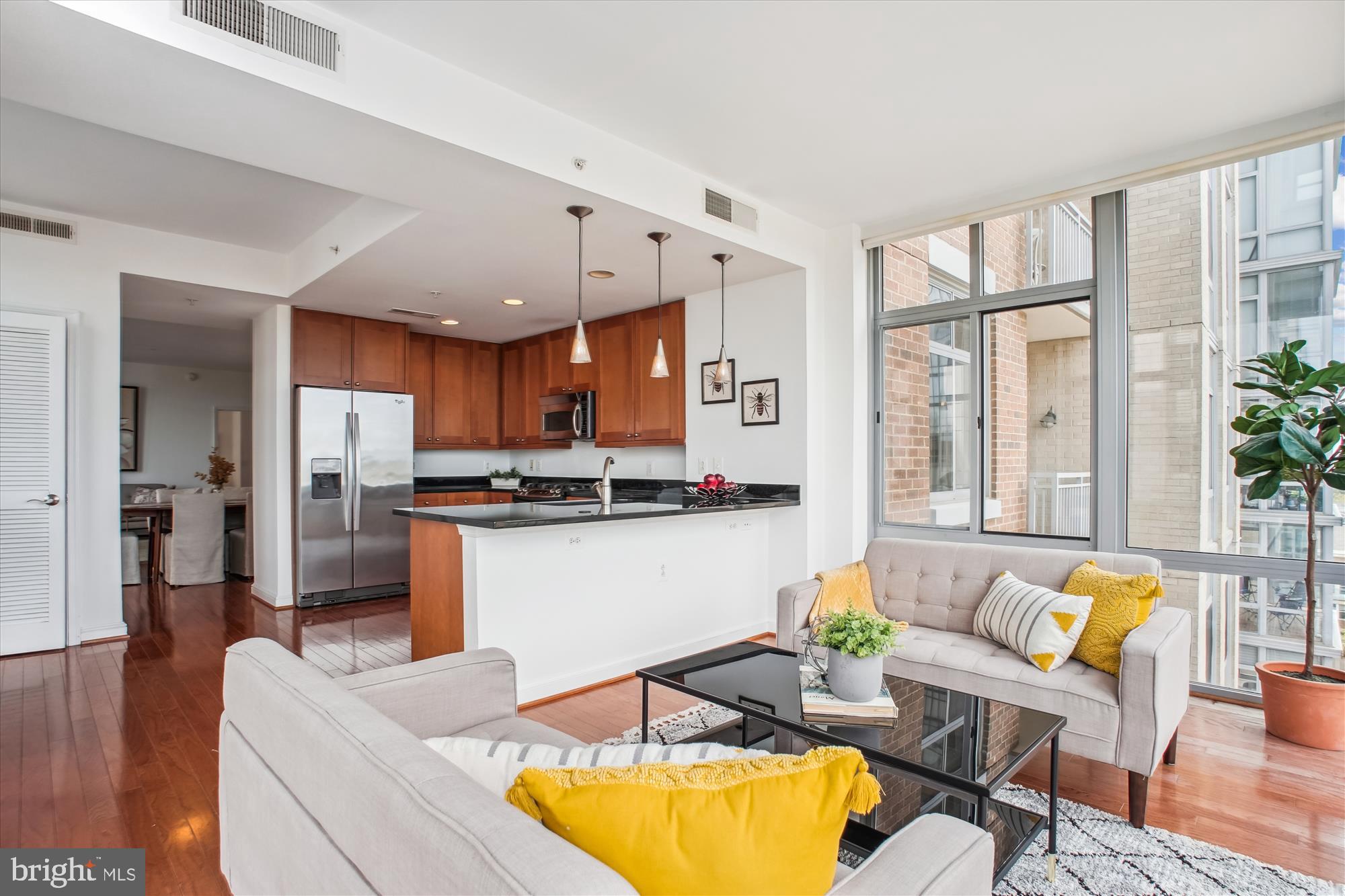 11990 Market Street, Unit 805 Reston, VA 20190 - Photo 18 of 53 a living room with stainless steel appliances kitchen island granite countertop furniture and a large window