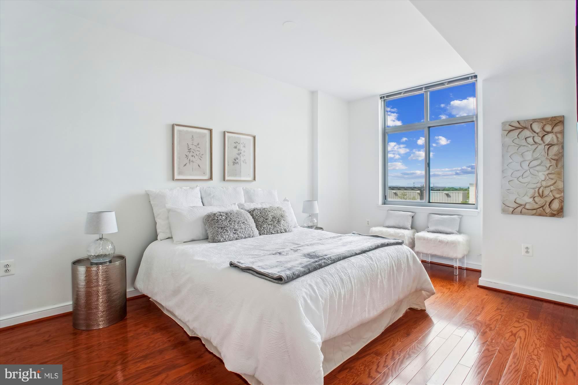 11990 Market Street, Unit 805 Reston, VA 20190 - Photo 20 of 53 a bedroom with a bed and wooden floor