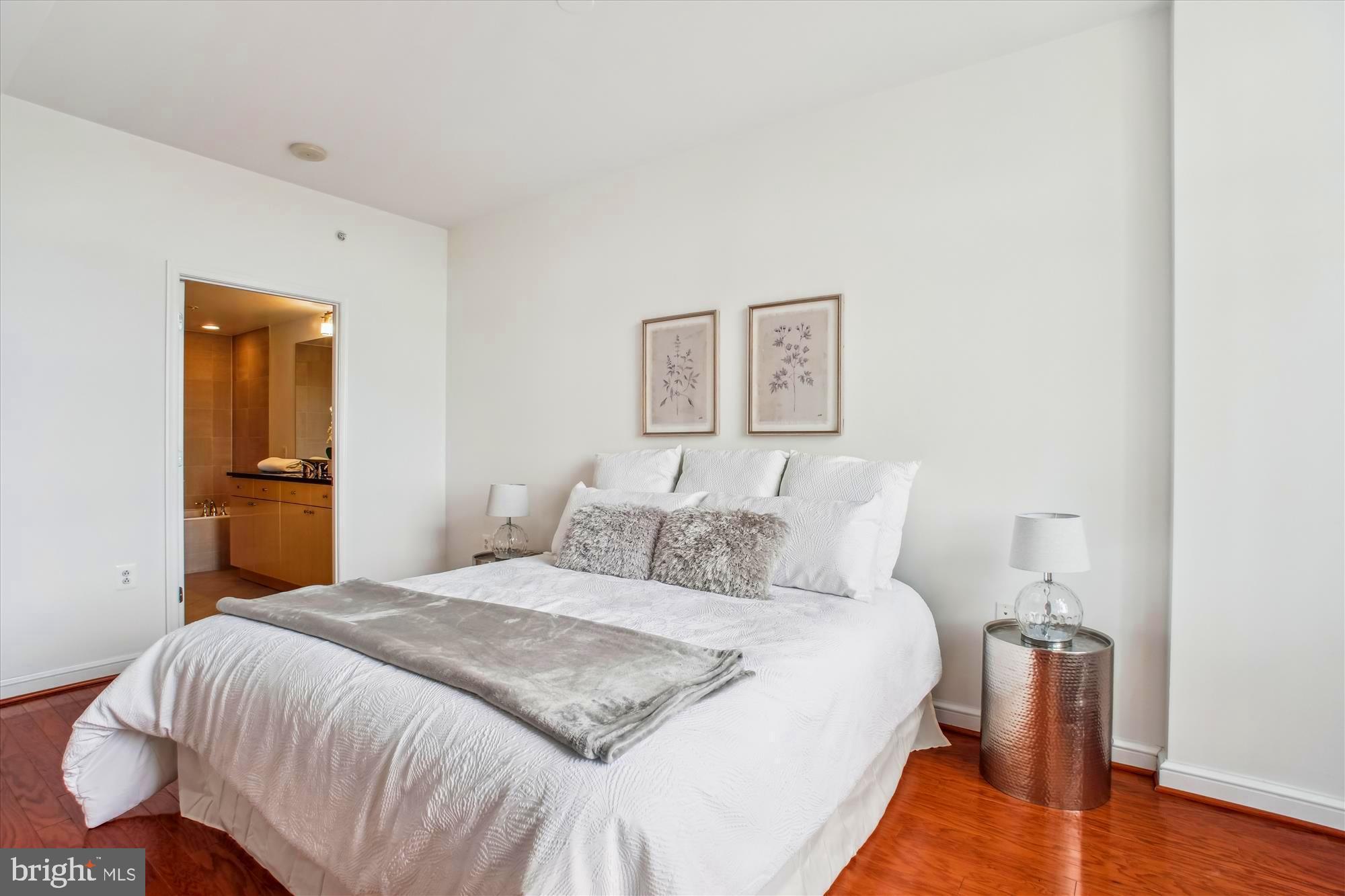 11990 Market Street, Unit 805 Reston, VA 20190 - Photo 21 of 53 a bedroom with a bed and a lamp
