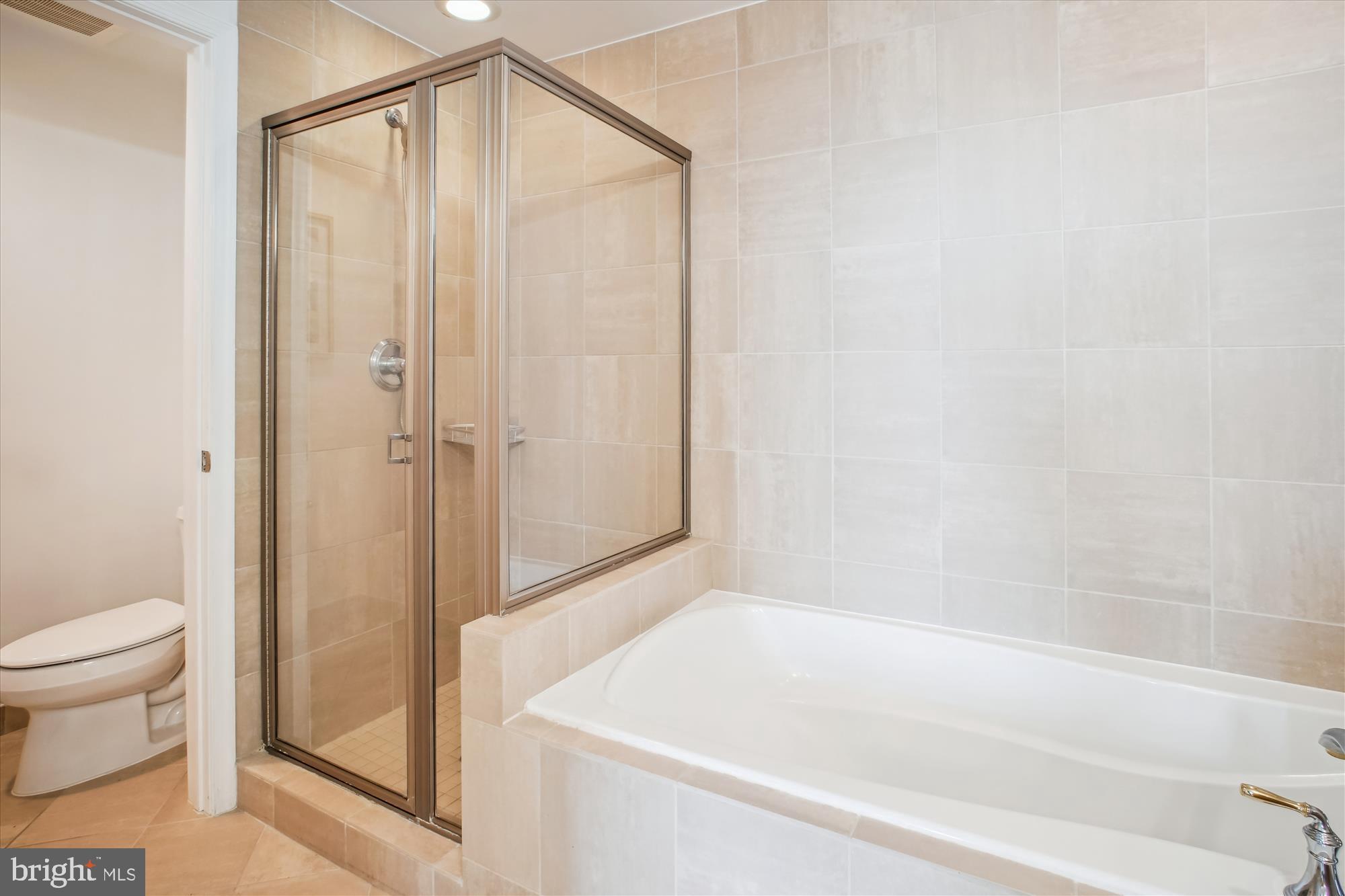 11990 Market Street, Unit 805 Reston, VA 20190 - Photo 23 of 53 a bathroom with a shower and a toilet