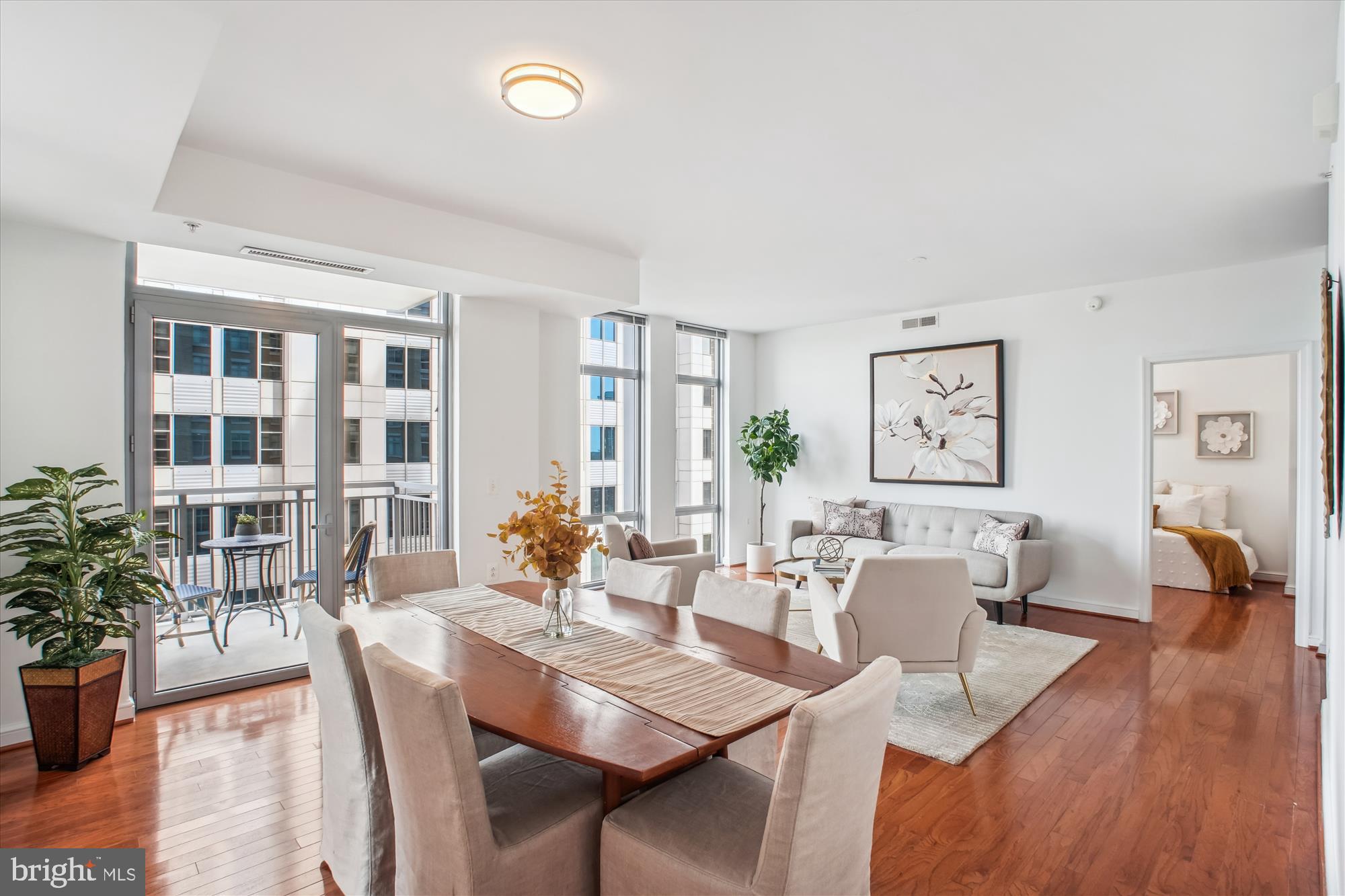 11990 Market Street, Unit 805 Reston, VA 20190 - Photo 7 of 53 a view of a dining room with furniture and wooden floor