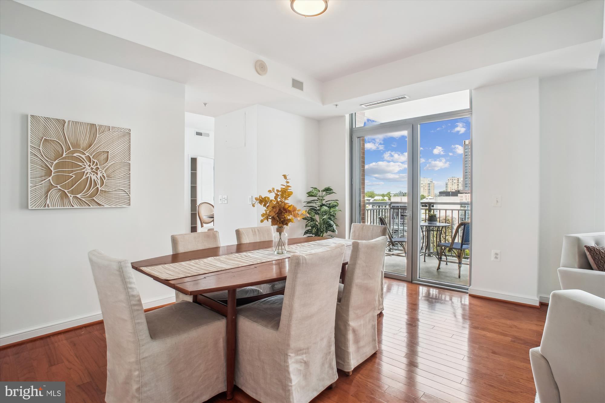 11990 Market Street, Unit 805 Reston, VA 20190 - Photo 9 of 53 a view of a dining room with furniture window and wooden floor