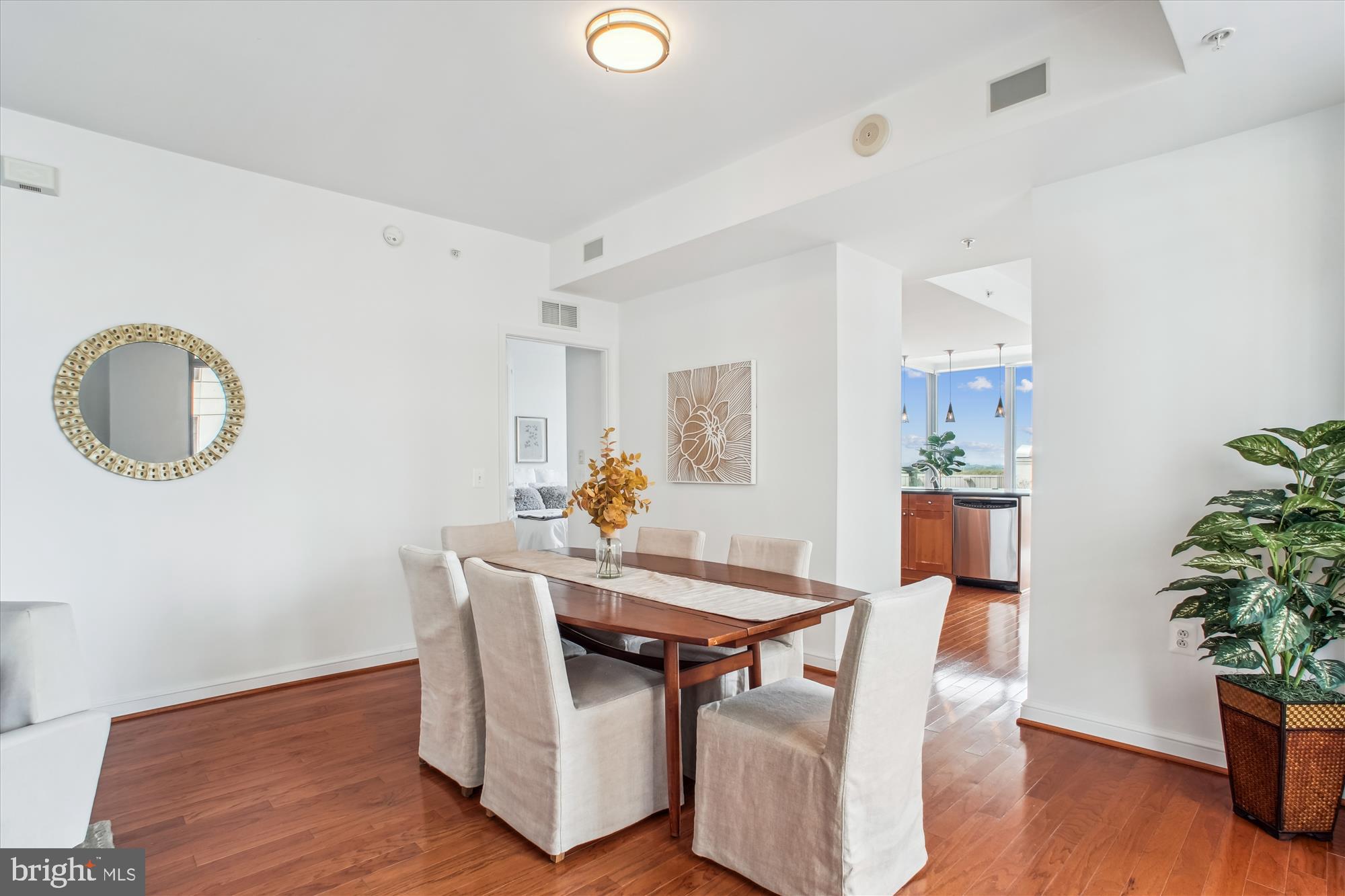 11990 Market Street, Unit 805 Reston, VA 20190 - Photo 10 of 53 a view of a dining room with furniture and wooden floor