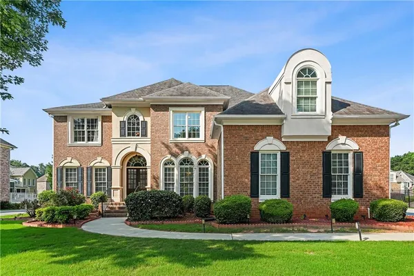 a front view of a house with a garden