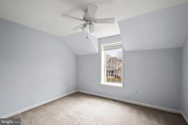 a view of a livingroom with a ceiling fan and window