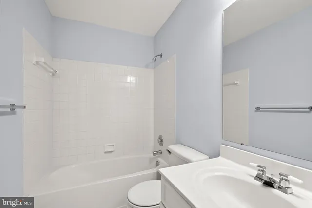 a bathroom with a tub shower and a sink