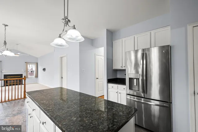 a view of staircase with lots of frames on wall and wooden floor
