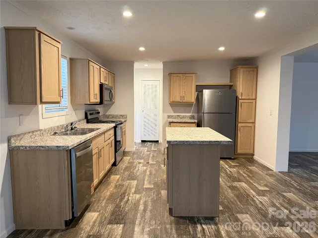 a kitchen with a sink appliances and cabinets