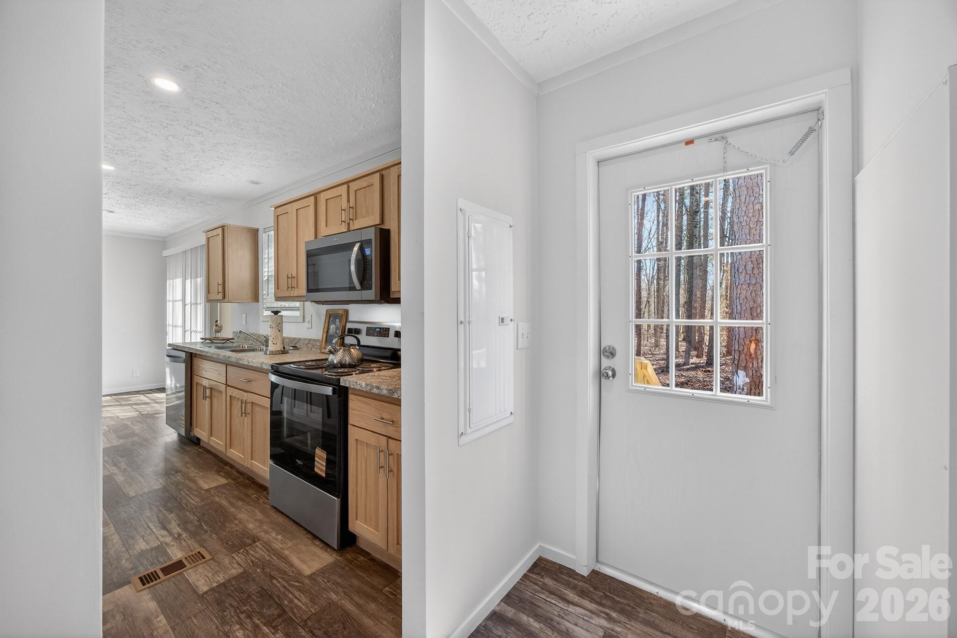 1395 Safrit Road Salisbury, NC 28146 - Photo 15 of 37 a kitchen with stainless steel appliances granite countertop a stove and a refrigerator