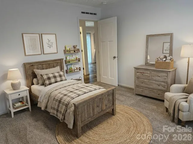 a bedroom with a bed a mirror and furniture