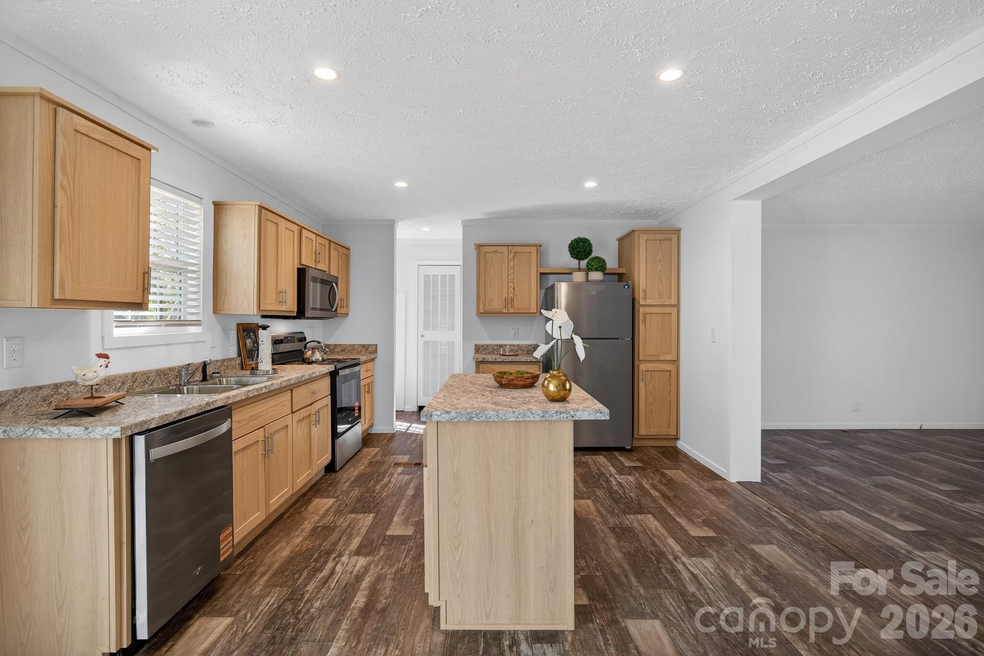 1395 Safrit Road Salisbury, NC 28146 - Photo 10 of 37 a kitchen with a stove a sink and a refrigerator