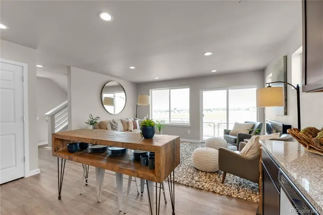 a living room with furniture a large window and a table