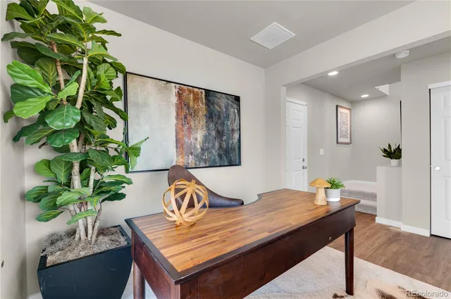 a view of a dining room with furniture and a potted plant