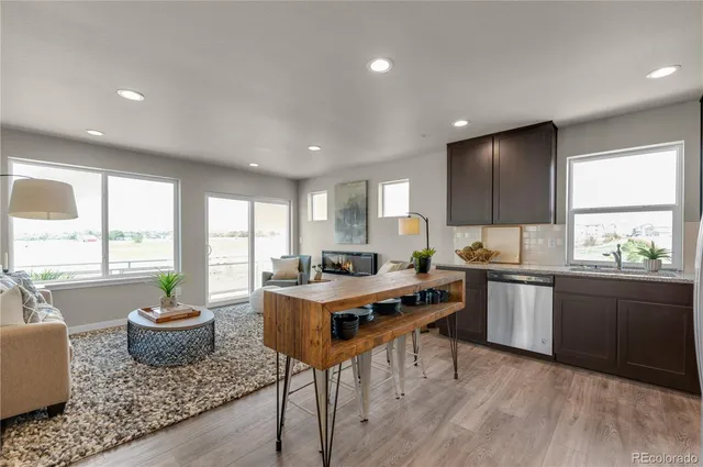 a kitchen with a stove a sink a counter space and dining table