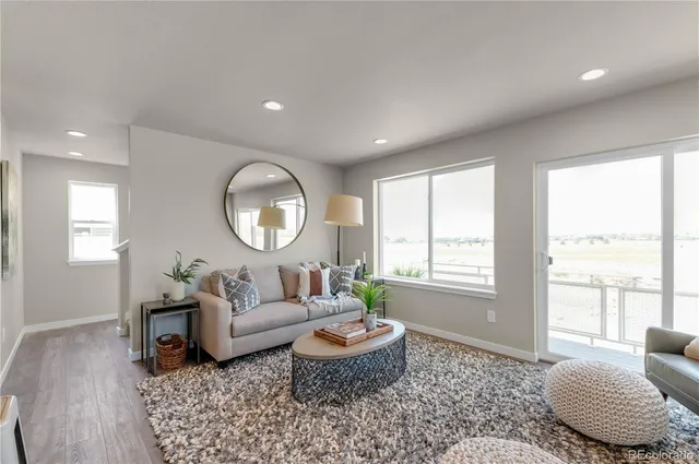 a living room with furniture and a large window
