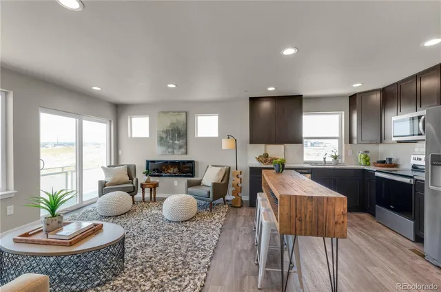 a large kitchen with a table and chairs