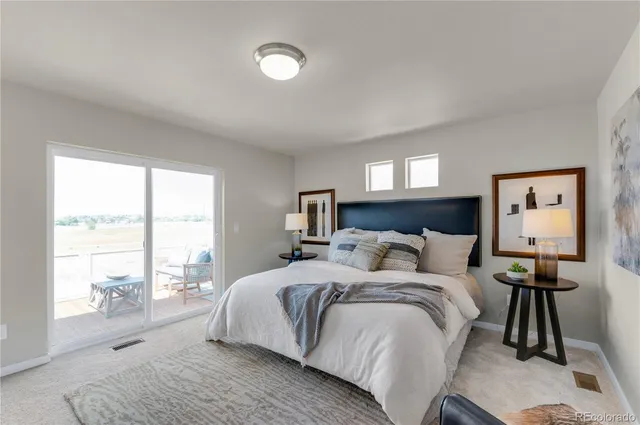 a bedroom with a bed and a large window