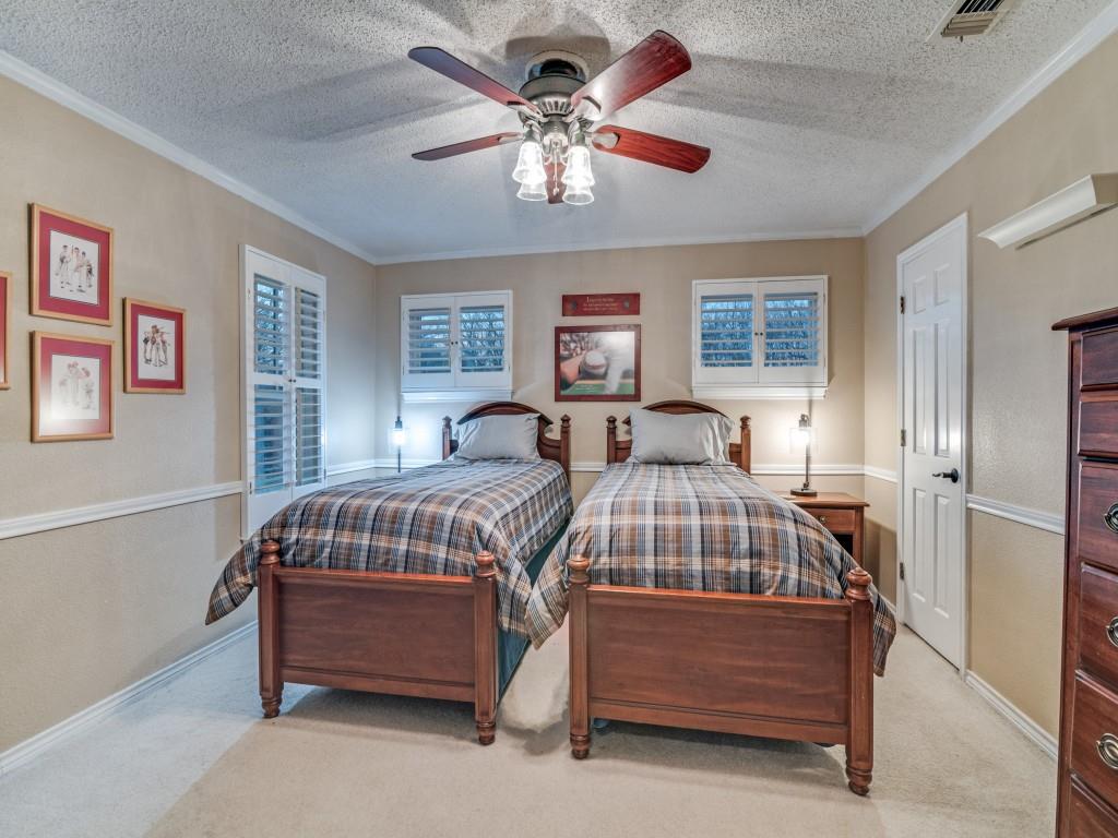 343 East Tripp Road Sunnyvale, TX 75182 - Photo 25 of 36 a bedroom with bed and a chandelier