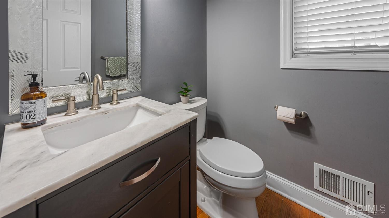 68 Timber Ridge Road North Brunswick, NJ 08902 - Photo 14 of 37 a bathroom with a granite countertop toilet sink and mirror