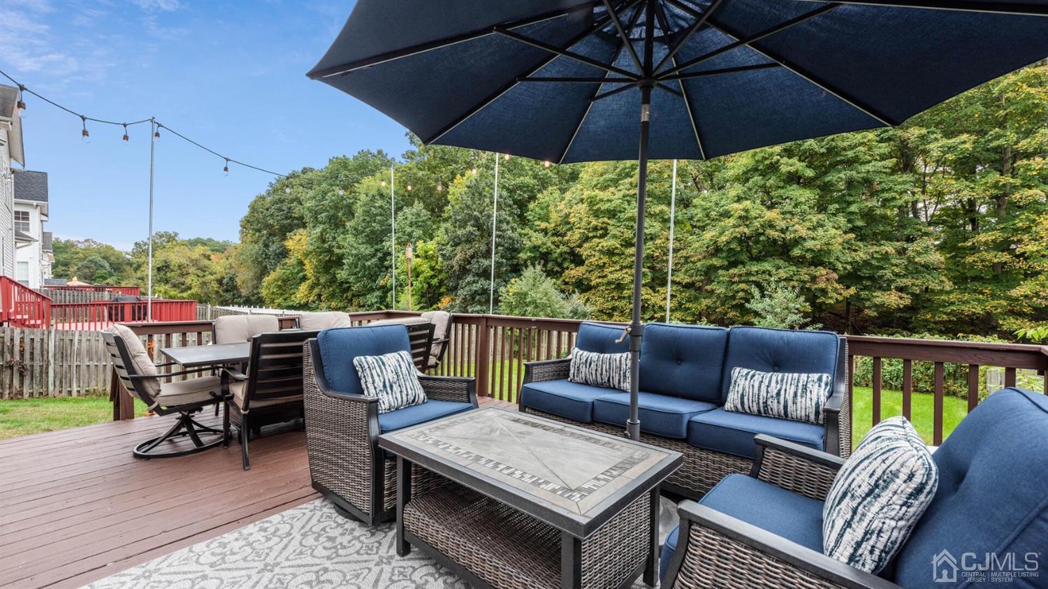 68 Timber Ridge Road North Brunswick, NJ 08902 - Photo 32 of 37 a view of an outdoor sitting area with furniture and umbrella