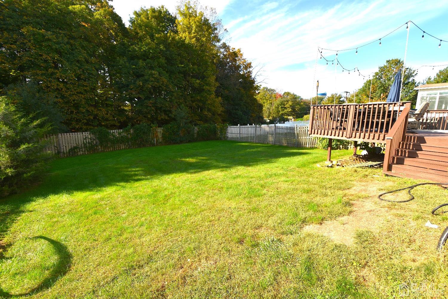 68 Timber Ridge Road North Brunswick, NJ 08902 - Photo 35 of 37 a view of garden with swimming pool and deck