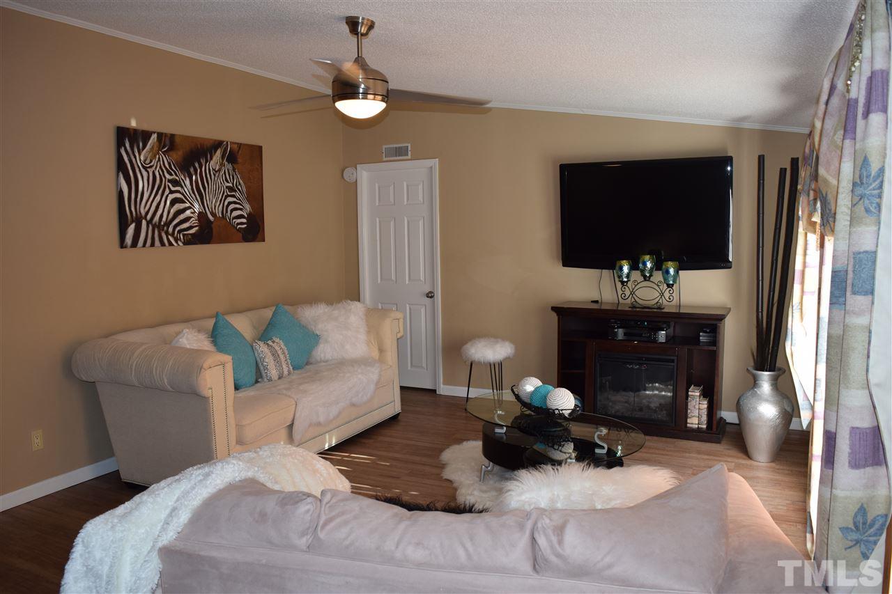 801 Sunshine Road Kenly, NC 27542 - Photo 3 of 24 Plenty of space in the living room! Door in left corner enters master bedroom.