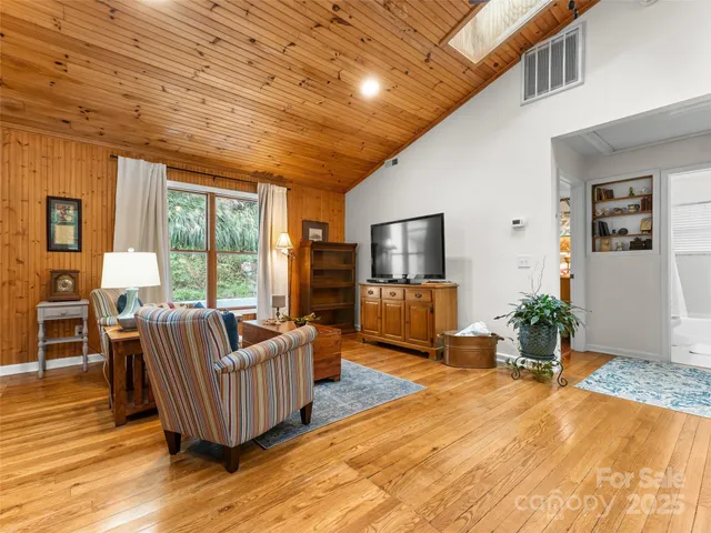 a living room with furniture windows and flat screen tv