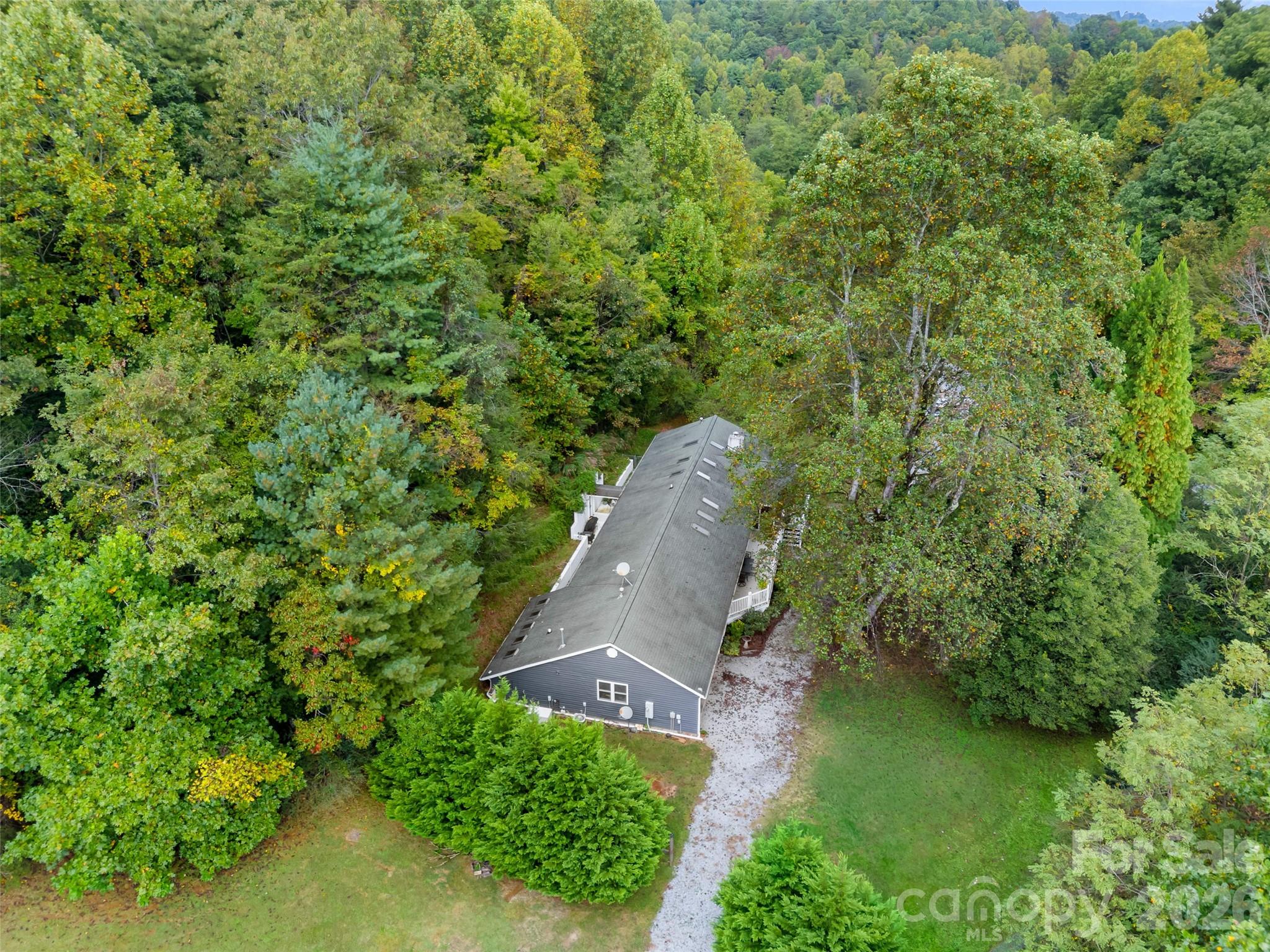 645 West Fork Creek Road Saluda, NC 28773 - Photo 25 of 44 an aerial view of a house with a yard