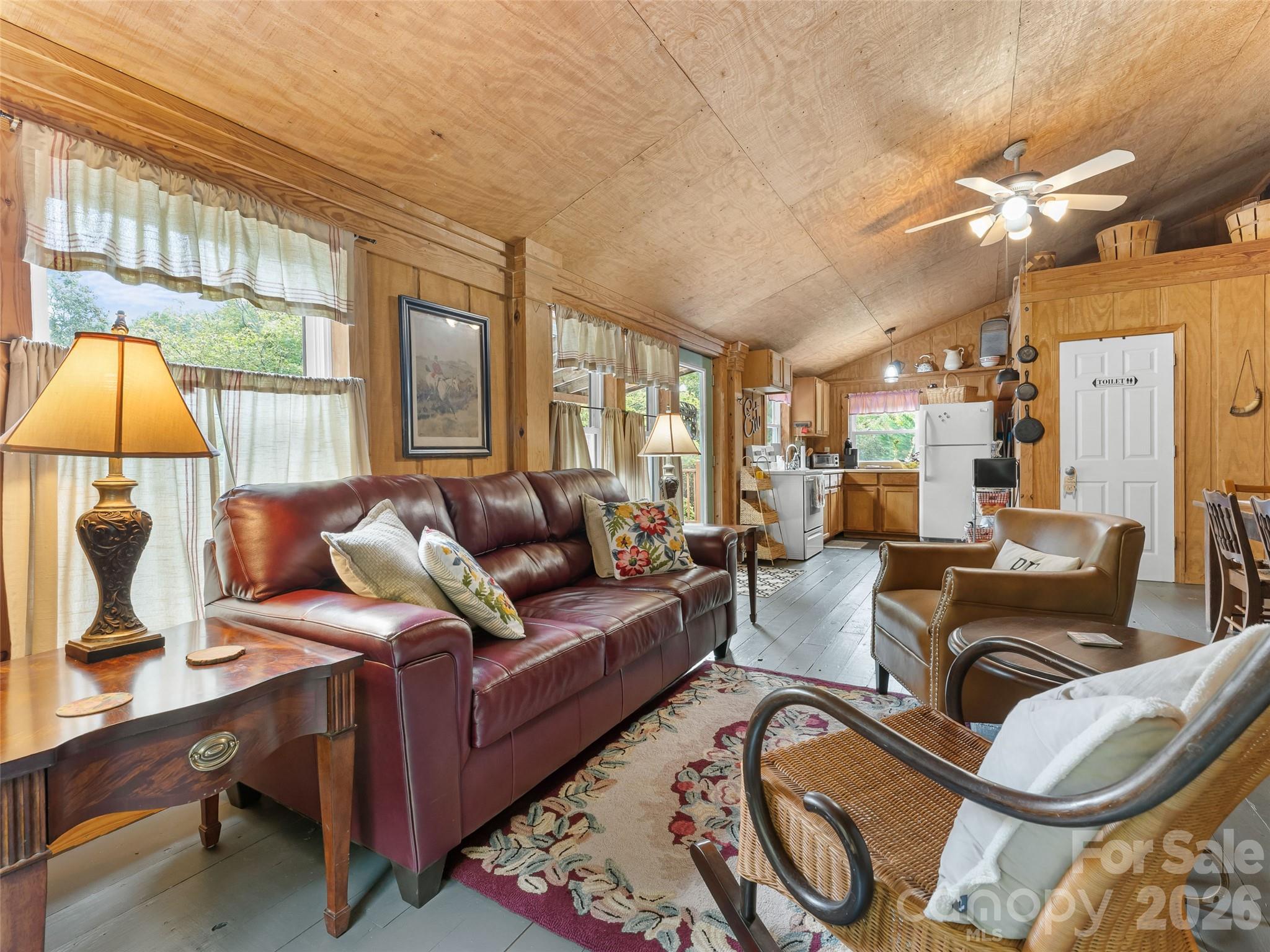 645 West Fork Creek Road Saluda, NC 28773 - Photo 29 of 44 a living room with furniture a lamp and a large window