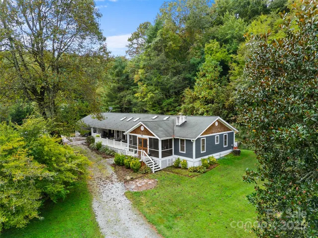 an aerial view of a house with a big yard