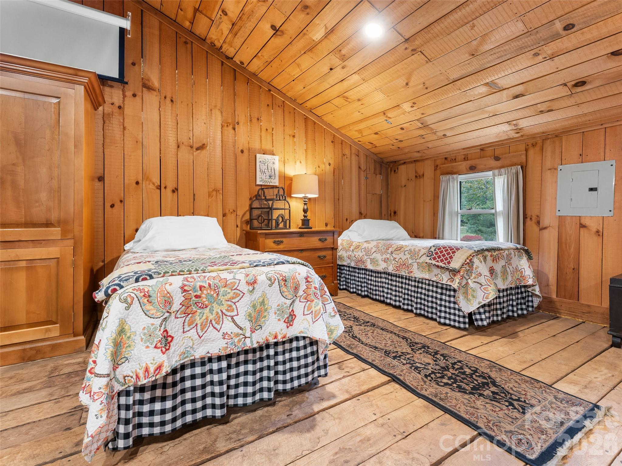 645 West Fork Creek Road Saluda, NC 28773 - Photo 35 of 44 a bedroom with double bed and a night stand