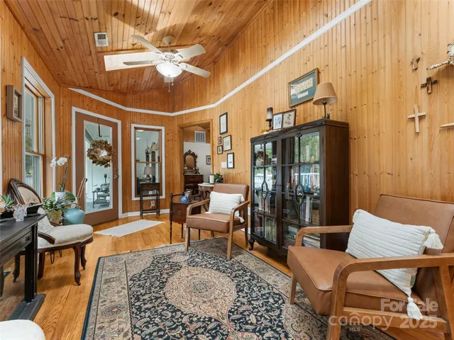 a living room with furniture a chandelier and a table