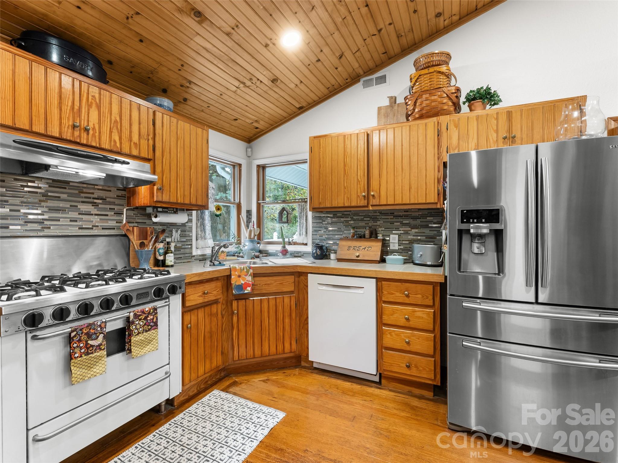 645 West Fork Creek Road Saluda, NC 28773 - Photo 8 of 44 a kitchen with stainless steel appliances granite countertop a refrigerator a stove and a sink