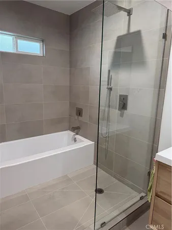 a bathroom with a bathtub and a shower