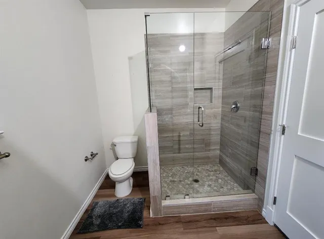 a bathroom with a toilet and a shower