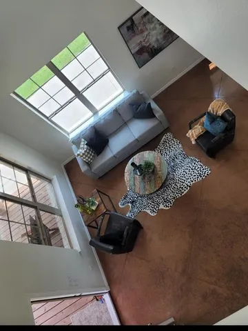 a living room with furniture and a book shelf