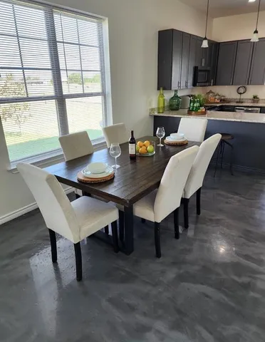a view of a dining room with furniture and window