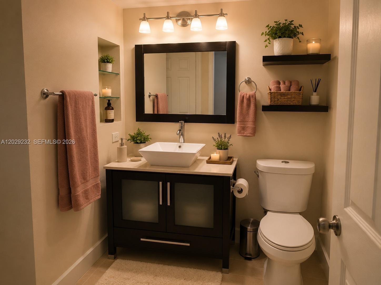 17100 North Bay Road, Unit 1605 Sunny Isles Beach, FL 33160 - Photo 33 of 52 a bathroom with a sink toilet and mirror
