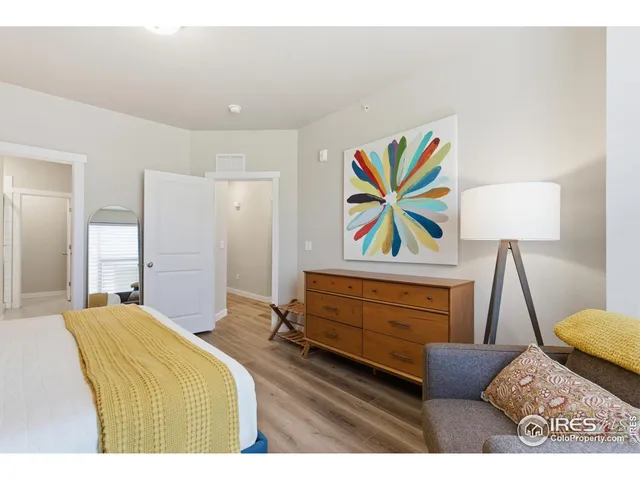 a bedroom with a bed and a painting on the wall