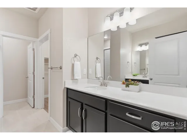 a bathroom with a sink vanity granite and a mirror