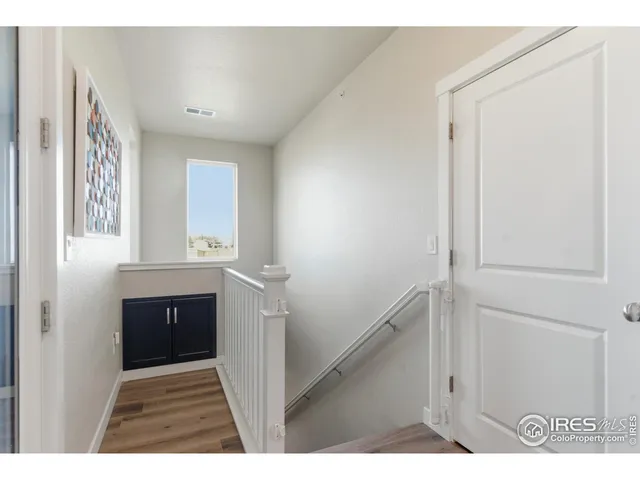 a view of hallway with a sink and a mirror