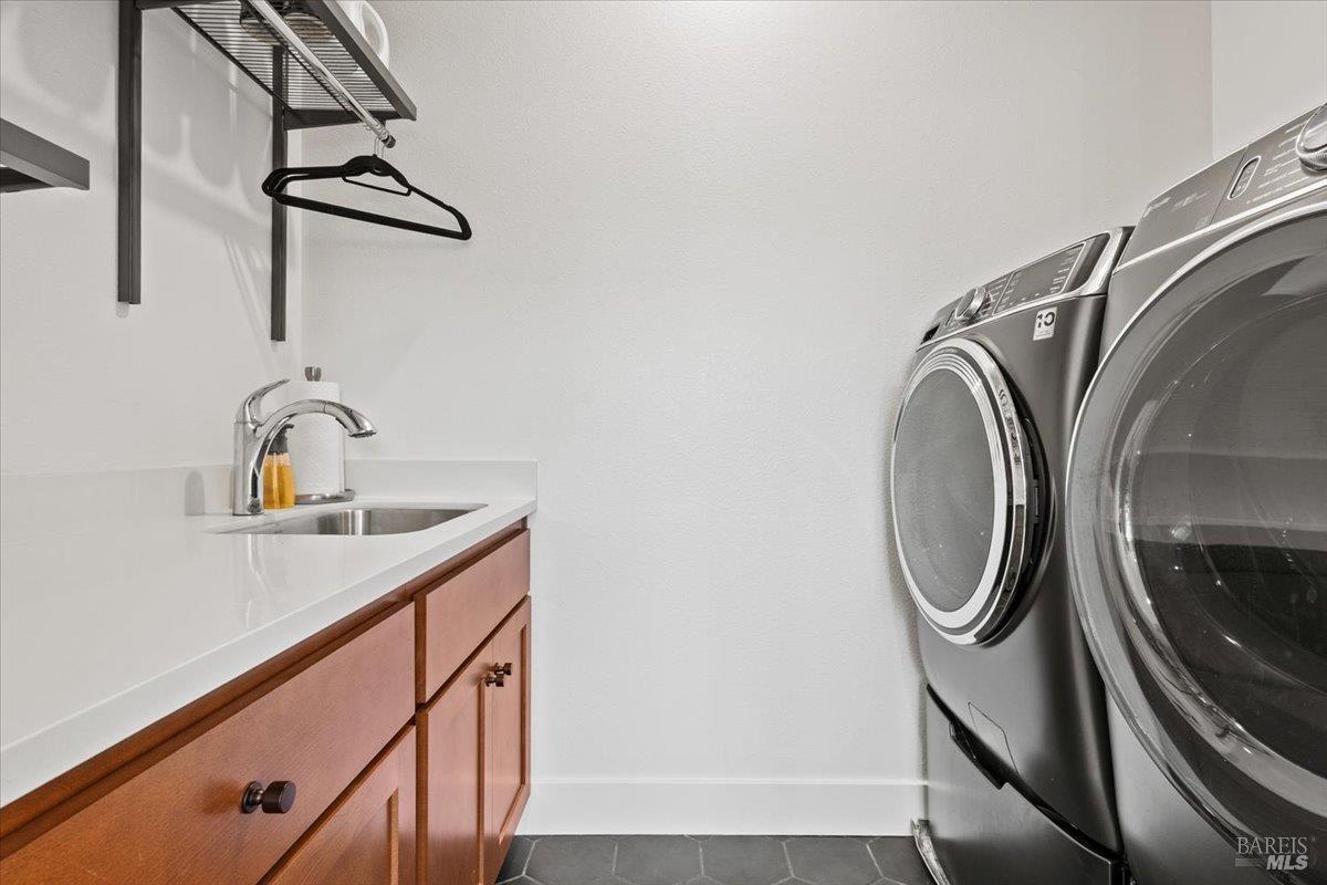 1469 Oak Circle Rohnert Park, CA 94928 - Photo 30 of 42 Convenient Upstairs Laundry Thoughtfully located near all three upstairs bedrooms, the spacious laundry room features built-in cabinetry, a utility sink, and ample workspace for everyday convenience.
