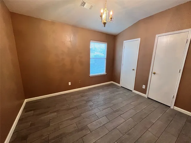 a view of hallway with closet and wooden floor