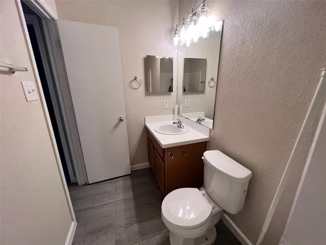 a white toilet sitting next to a bath tub