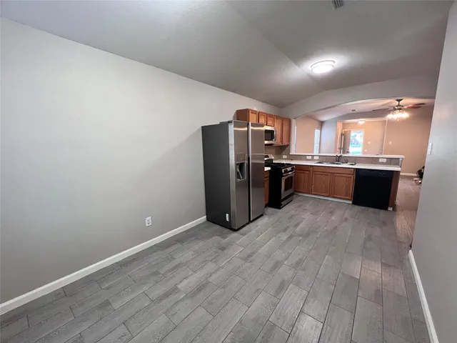 a view of walk in closet with empty racks