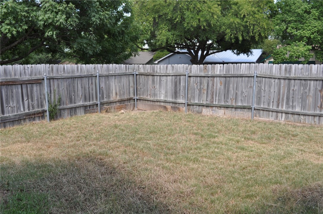 5916 B Cherry Loop Austin, TX 78745 - Photo 10 of 10 a view of a backyard with a small cabin and a chair